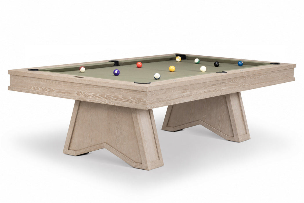 A modern pool table with a light beige wood-grain frame and legs, featuring a sage green felt surface with several colorful billiard balls, shown on a white background.