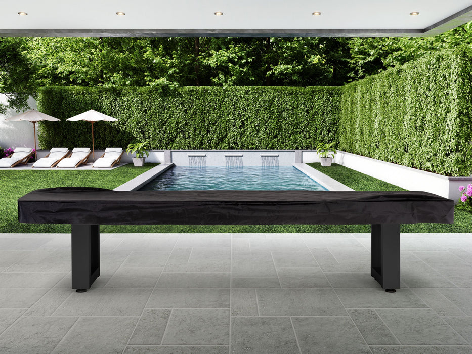 American Heritage Lanai 9' Outdoor Shuffleboard Table in Obsidian Black on patio by the pool.