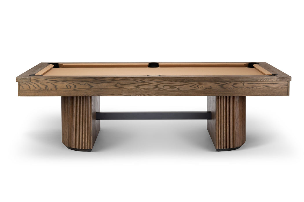 A modern pool table with a medium brown wood grain frame, a light tan felt playing surface, and chunky ribbed wooden legs, shown against a plain white background.