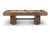A modern pool table with a medium brown wood grain finish, featuring a light tan felt playing surface, a black metal support beam in the center, and colorful billiard balls arranged on the table, set against a plain white background.