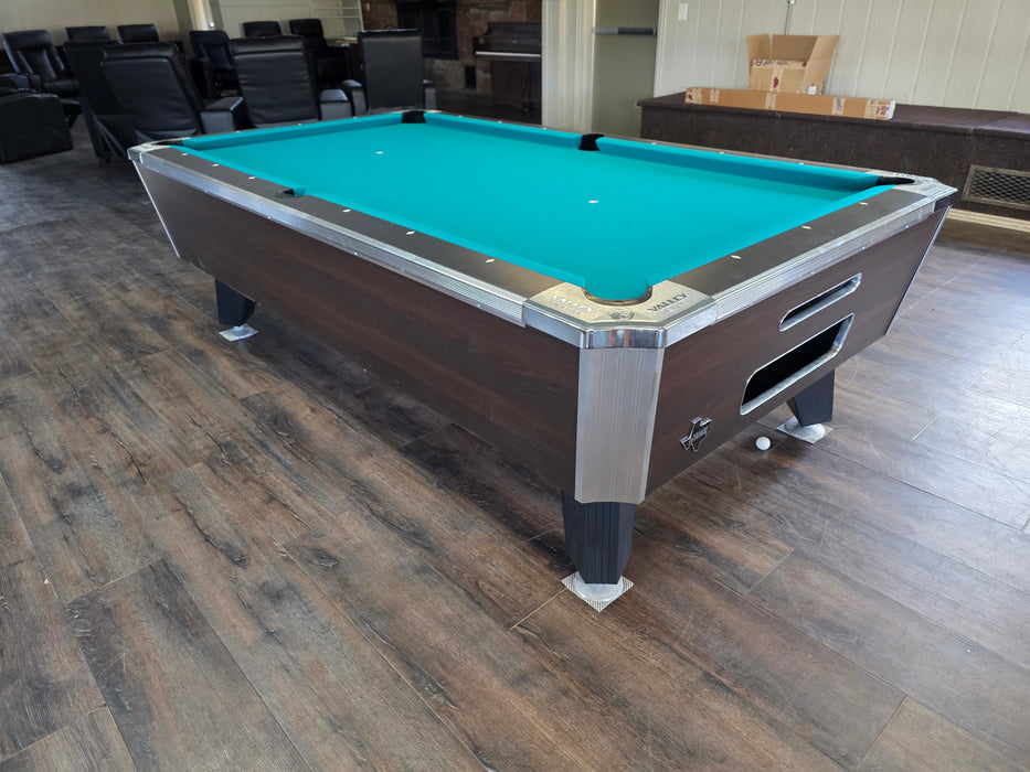 Pool table with a blue felt surface in an indoor setting